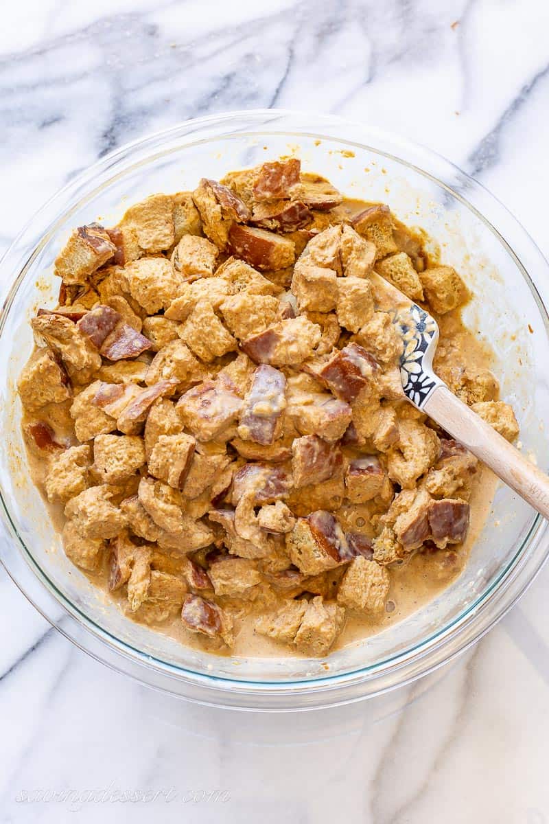 A bowl of bread cubes tossed in a mixture of pumpkin, spices and half-and-half