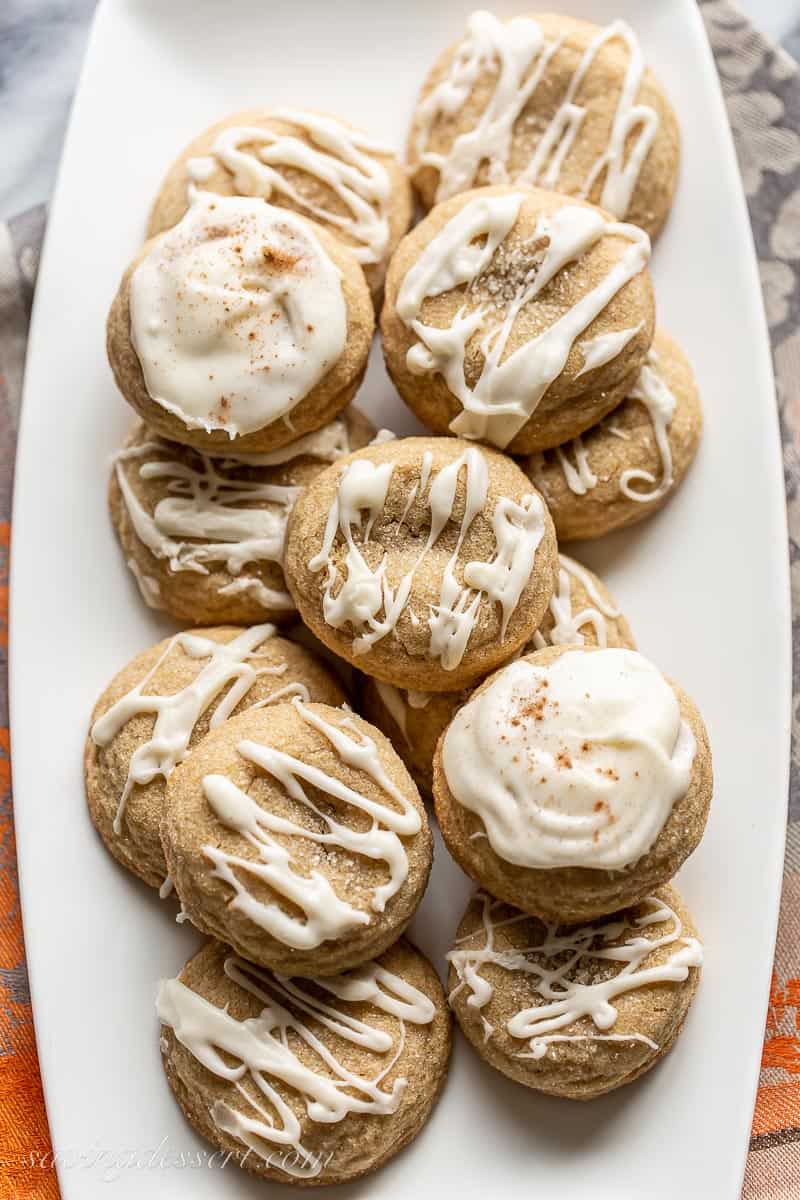 A white tray filled with iced pumpkin spice cookies