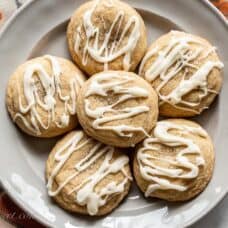 Overhead view of a plate of pumpkin spice cookies with a drizzled icing on top