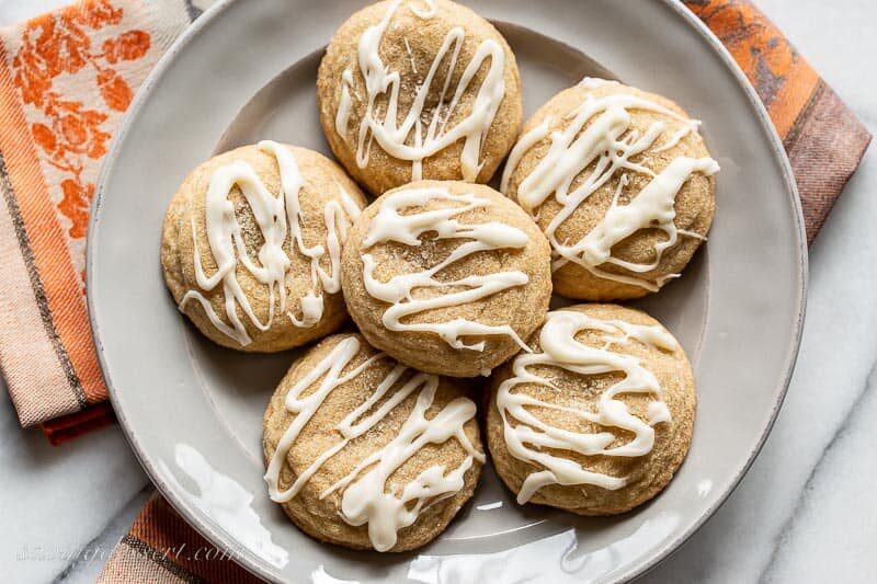 Overhead view of a plate of pumpkin spice cookies with a drizzled icing on top