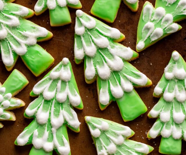 Cut out Christmas tree cookies with snow white icing