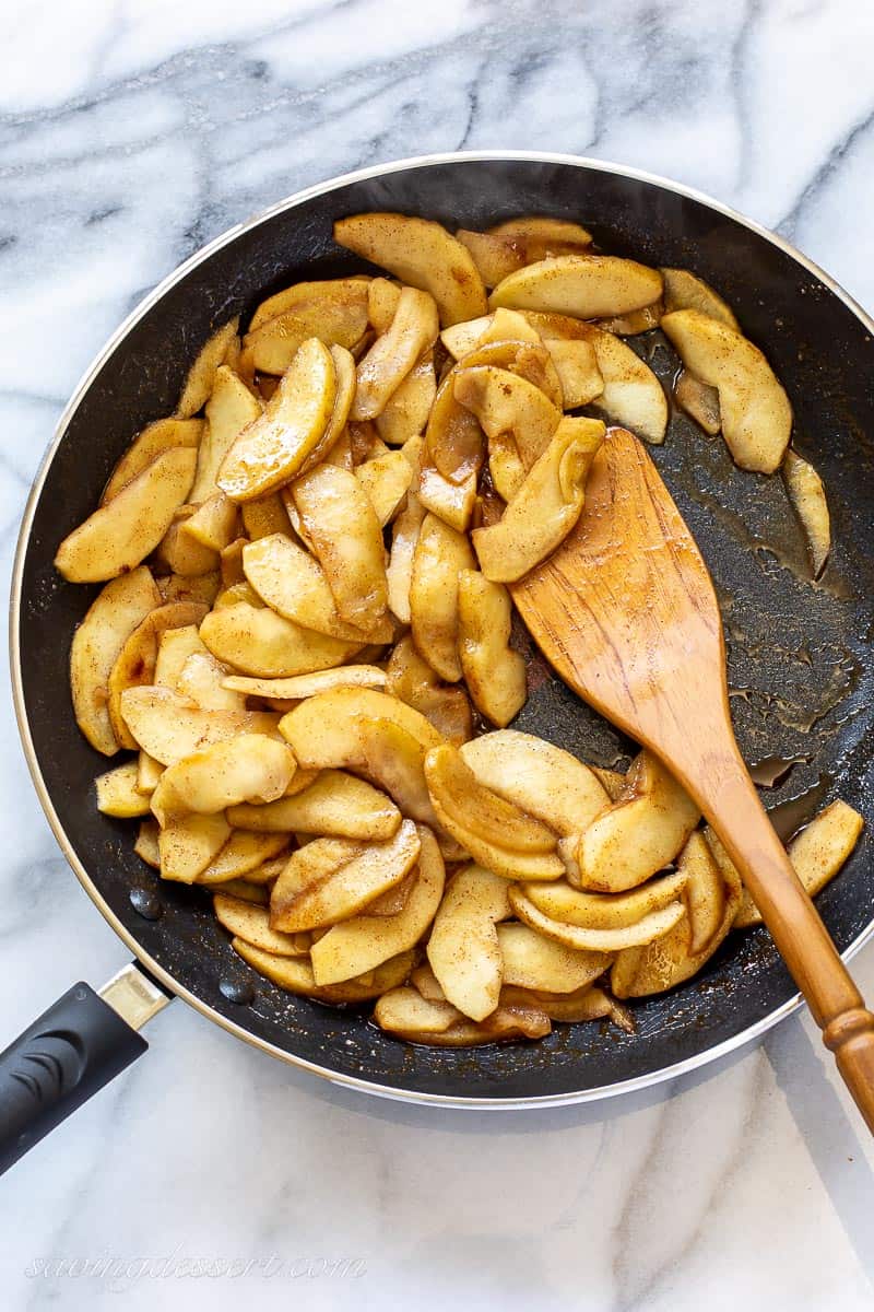 a skillet filled with sliced apples