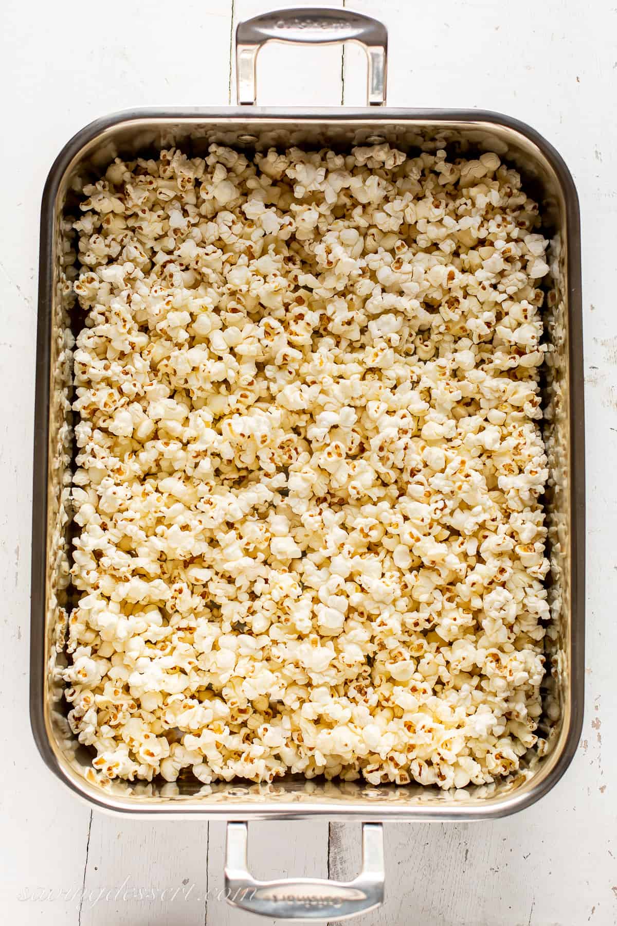 A large roasting pan filled with fresh popped popcorn