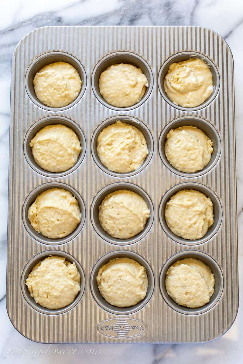 A muffin tin with batter in each of the wells