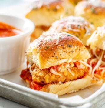 A platter filled with parmesan chicken sliders