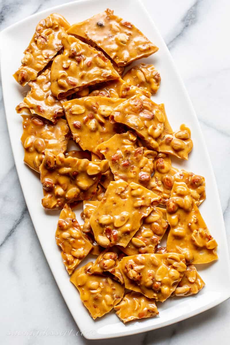 Overhead view of a platter filled with pieces of peanut brittle