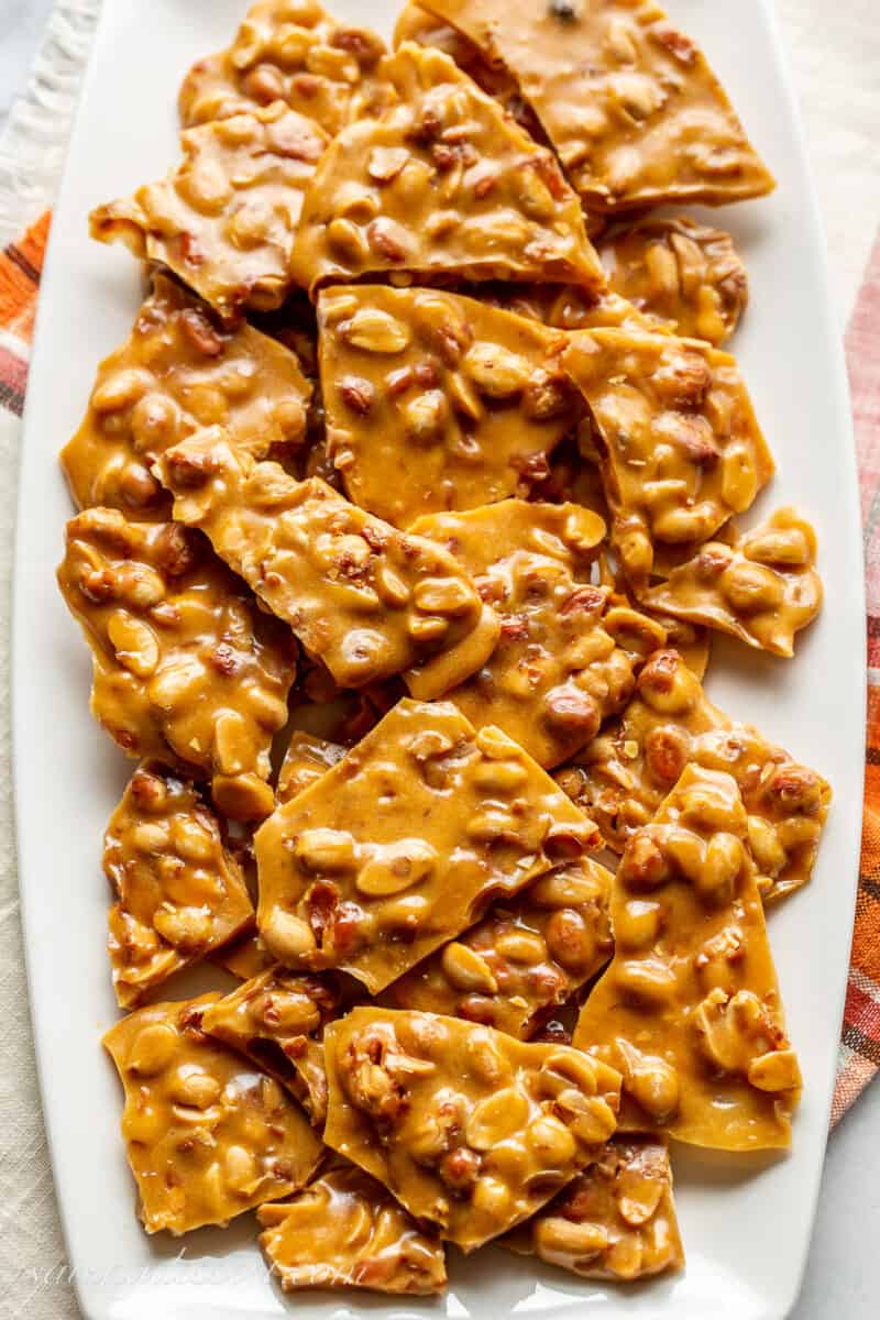 closeup of a platter of homemade pieces of peanut brittle