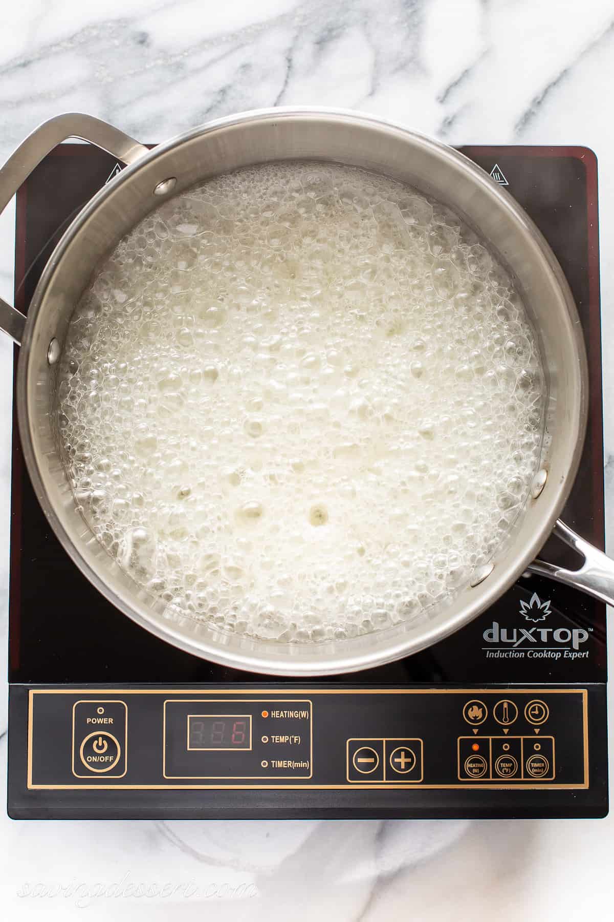 A simple syrup mixture boiling in a saucepan