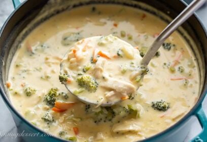 a ladle scooping out chicken broccoli soup from a pot