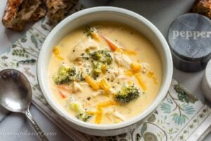 a bowl of broccoli soup with carrots and chicken