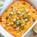 buffalo chicken dip topped with scallions and blue cheese