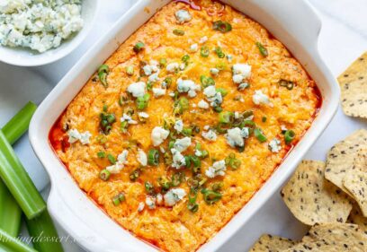 buffalo chicken dip topped with scallions and blue cheese