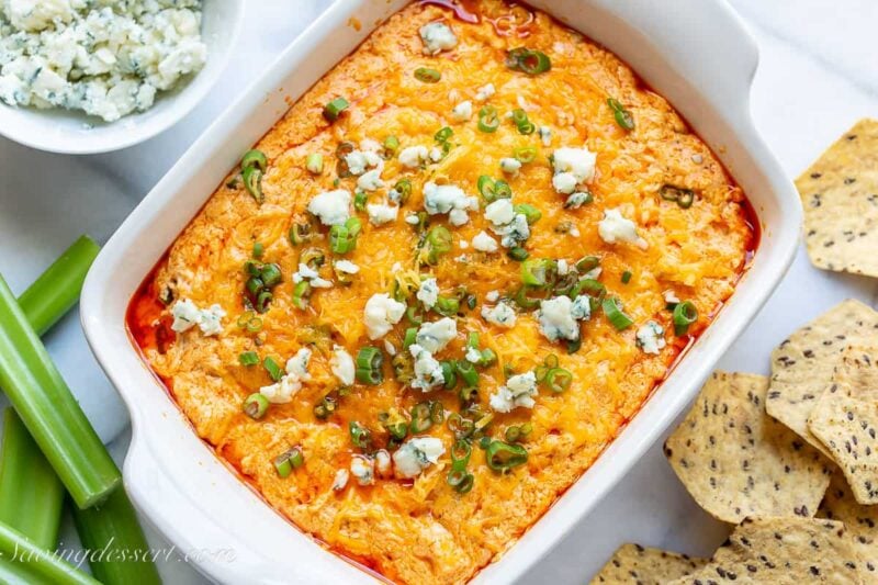 buffalo chicken dip topped with scallions and blue cheese