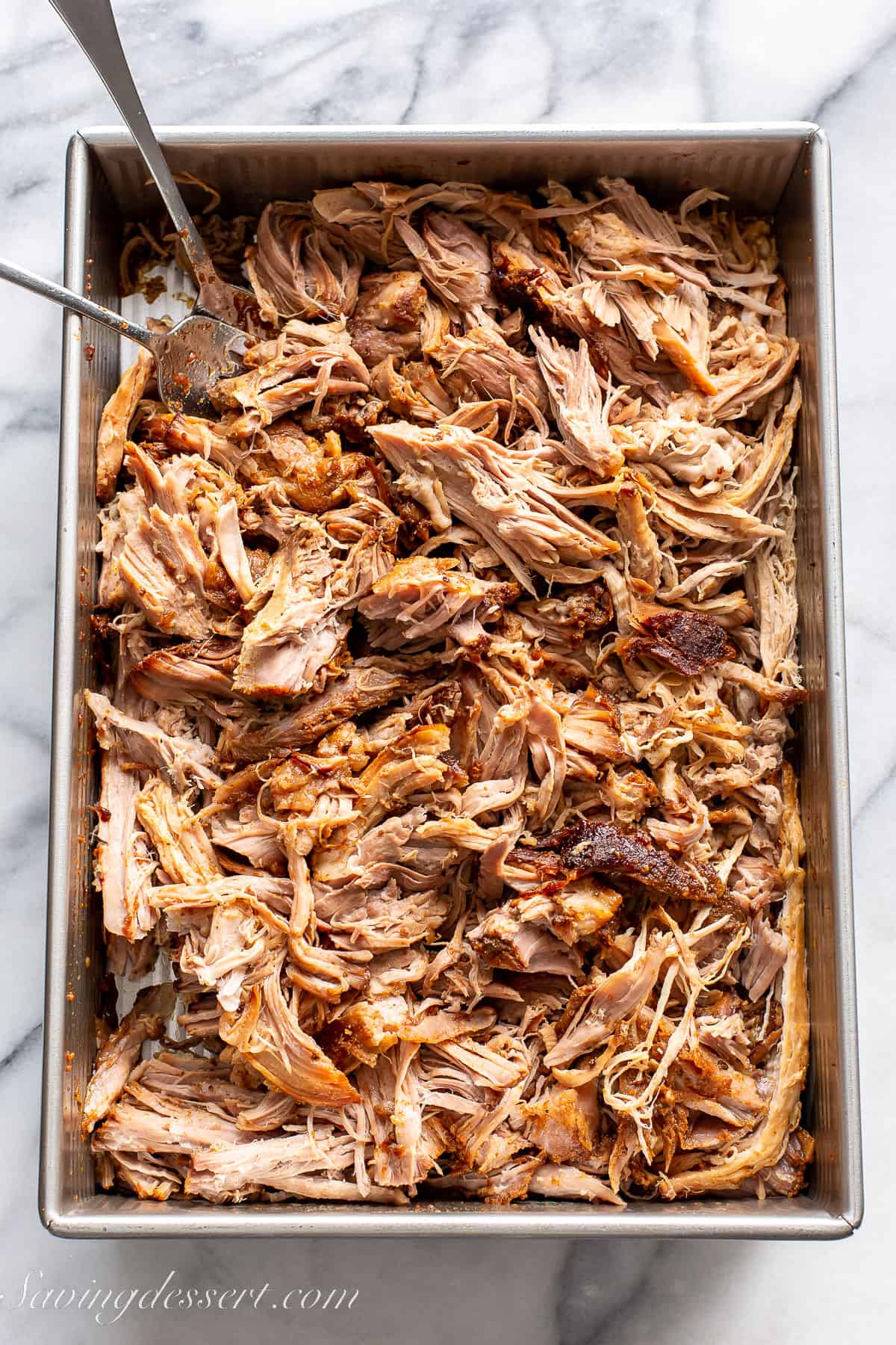 a baking pan filled with shredded pulled pork