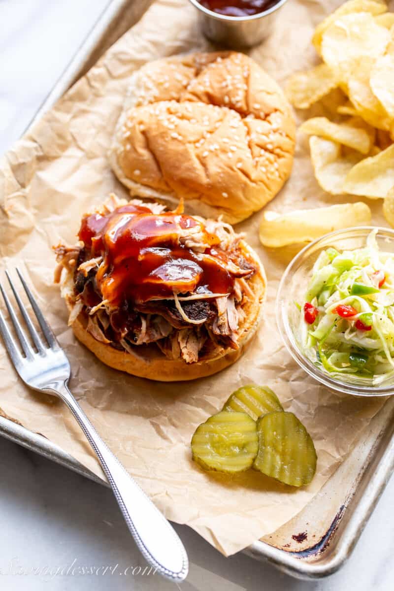BBQ sauce poured over a pulled pork sandwich with slaw