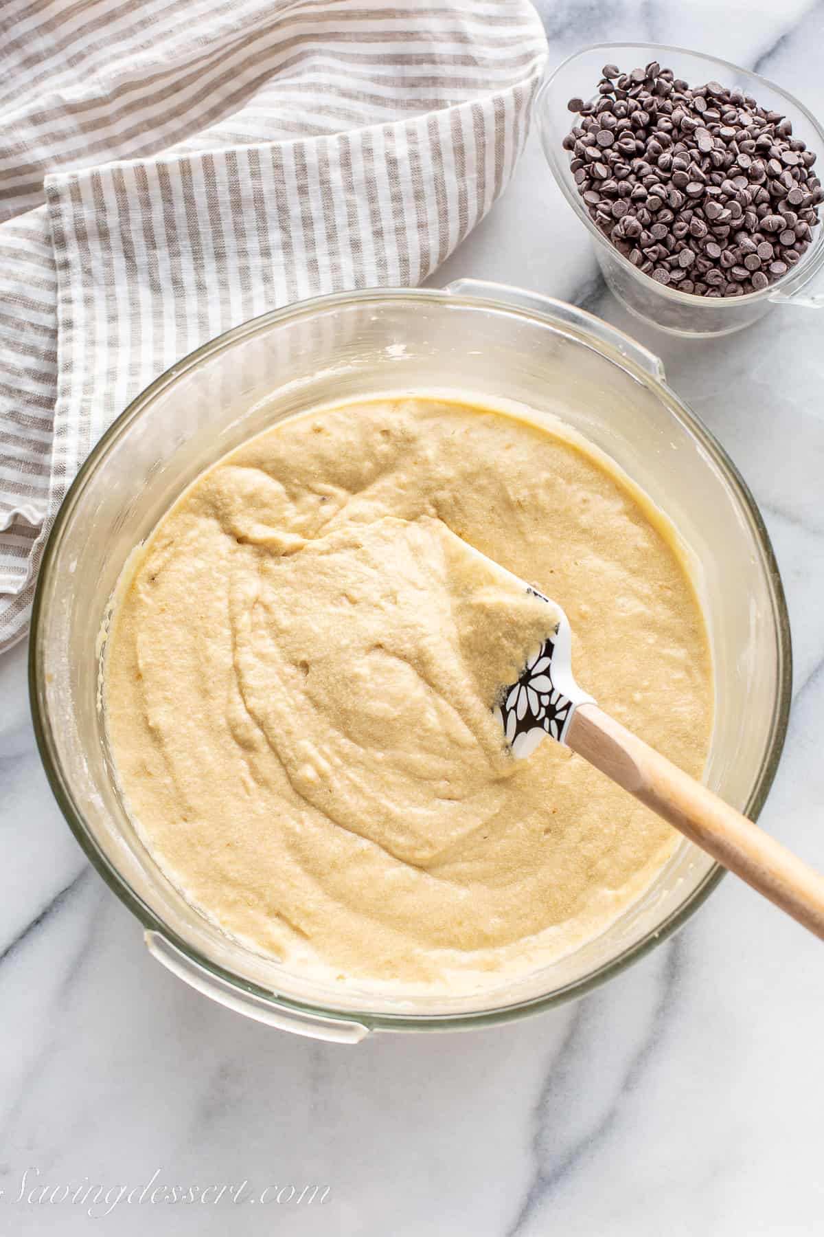 a bowl of cake batter with a spatula