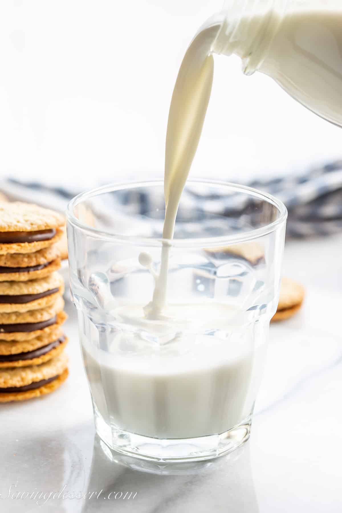 milk being poured into a glass