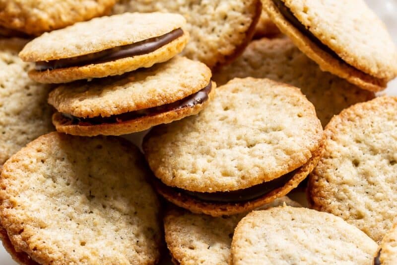 An overhead photo of a platter of Brussels Cookies with a chocolate ganache filling.