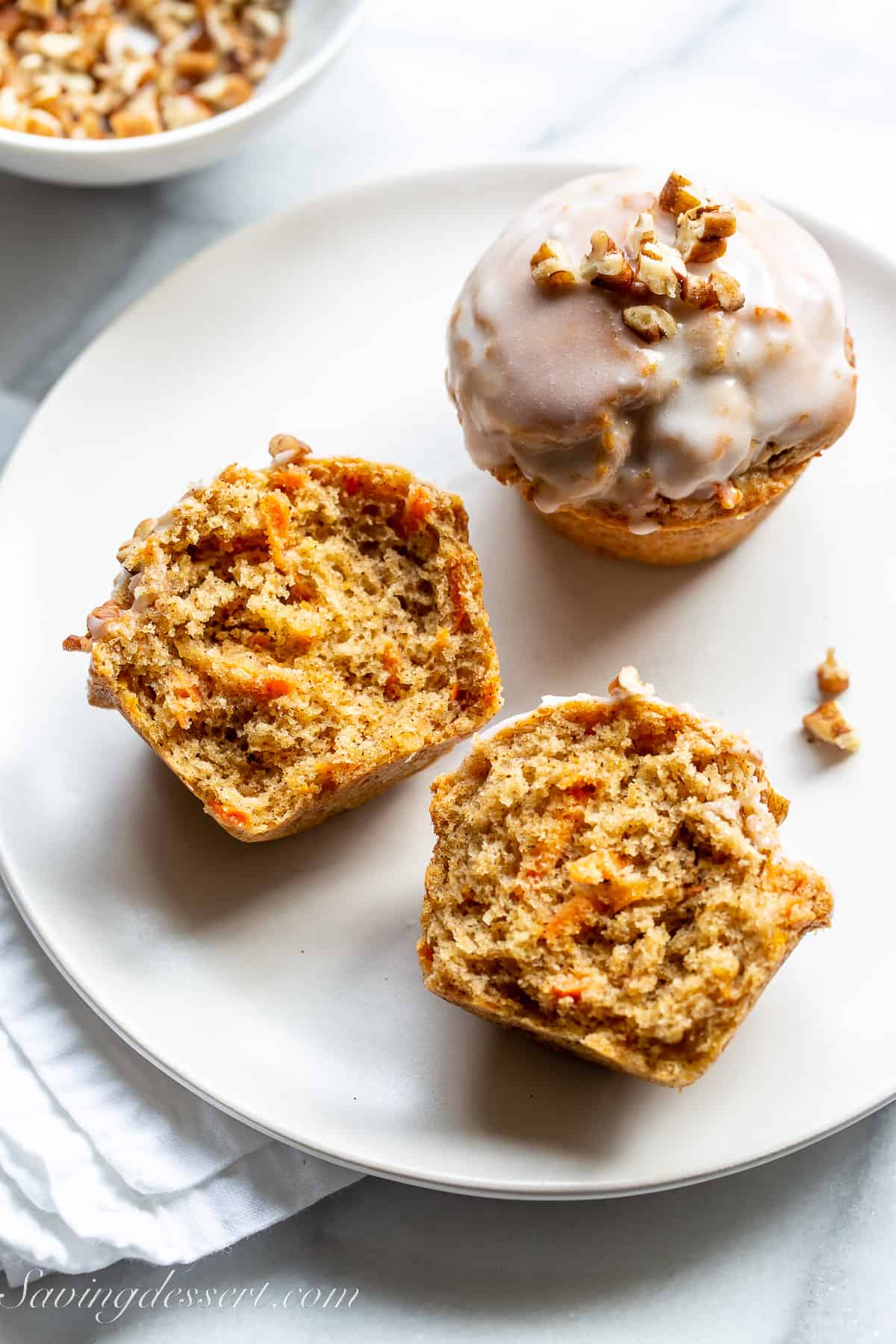 carrot cake muffin split open on a plate