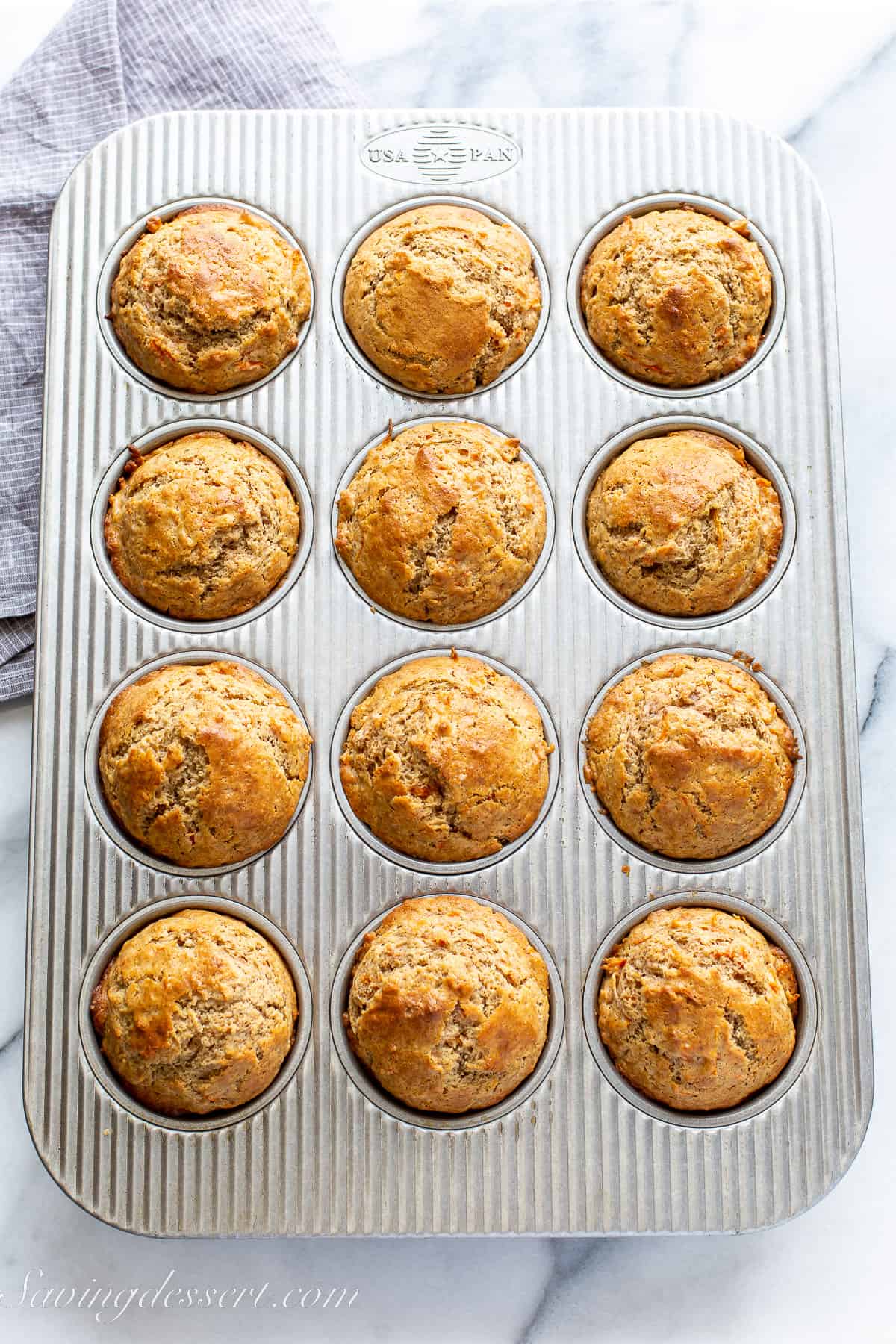 a tin of carrot cake muffins fresh from the oven