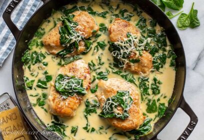 a skillet filled with chicken Florentine topped with Parmesan
