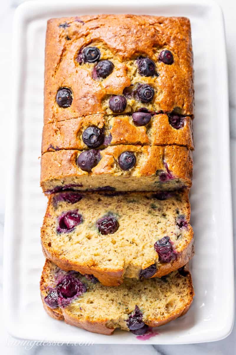 Overhead view of a sliced loaf of blueberry banana bread