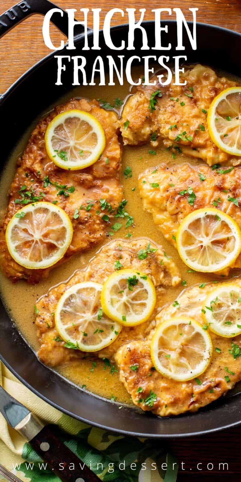 A closeup of a skillet filled with chicken cutlets in a buttery lemon sauce
