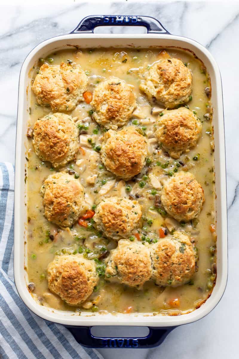 a baked chicken pot pie casserole with herb biscuits on top