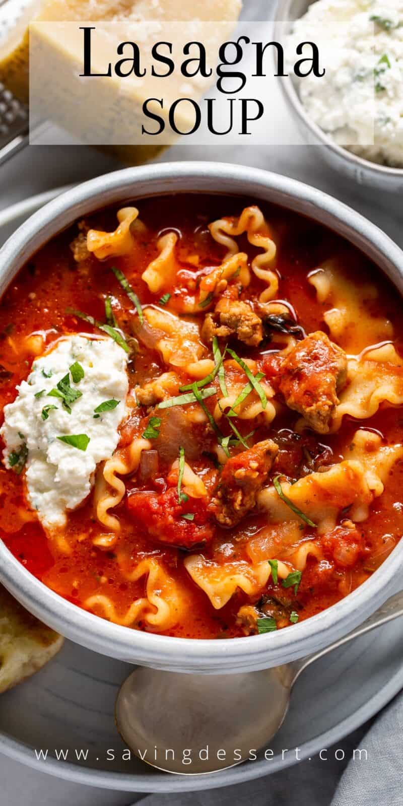 Overhead view of a bowl of lasagna soup with a dollop of ricotta cheese in the middle