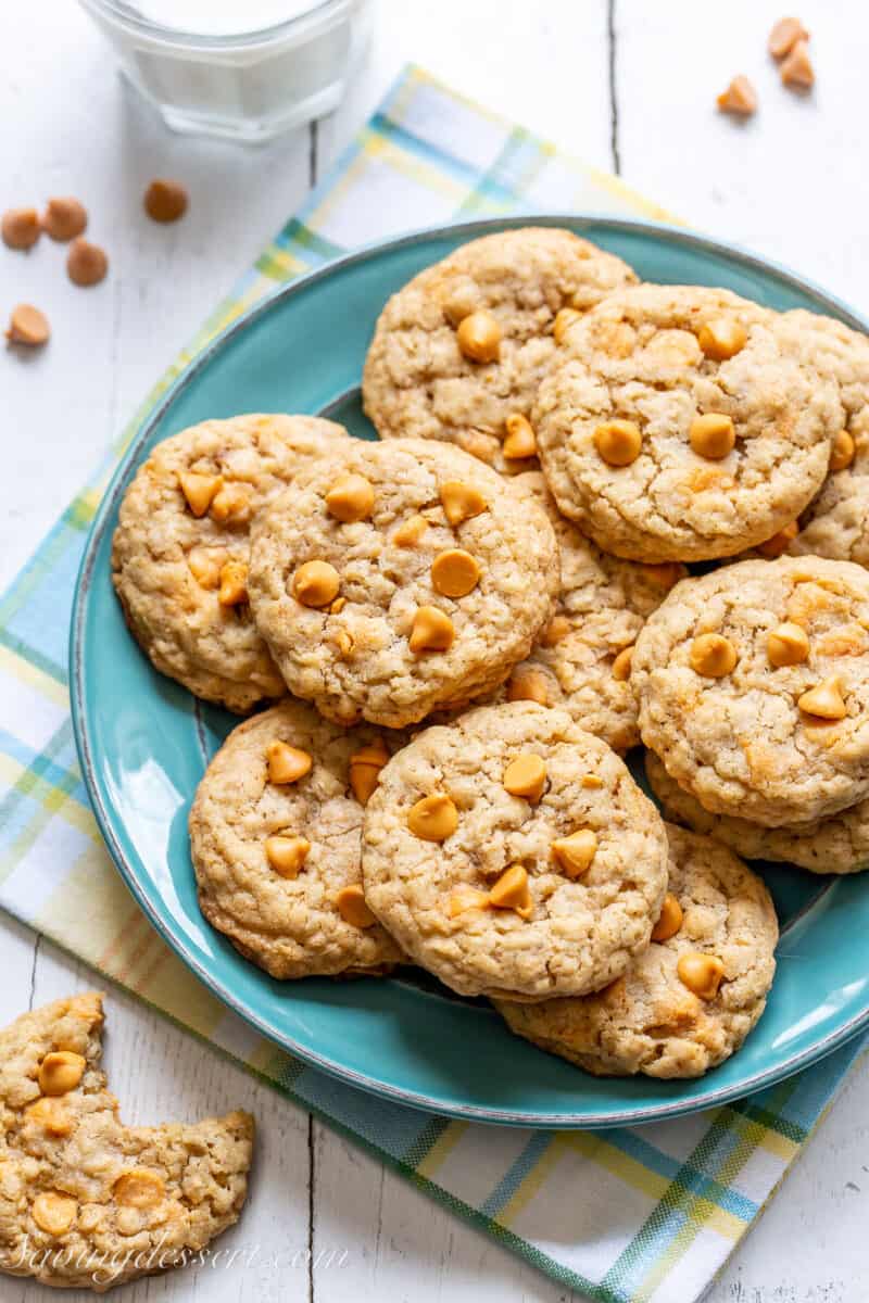 a blue plate with a pile of oatmeal cookies on top