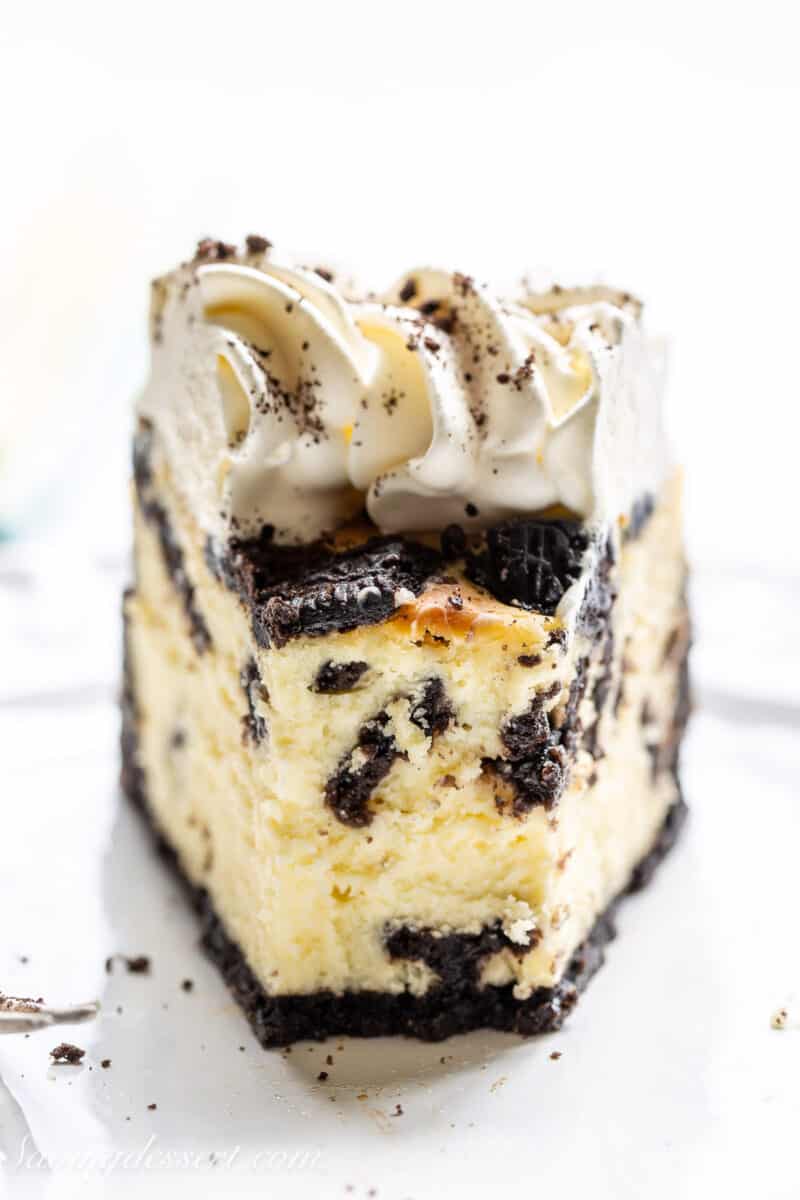 closeup front view of a slice of oreo cheesecake with an oreo cookie crust