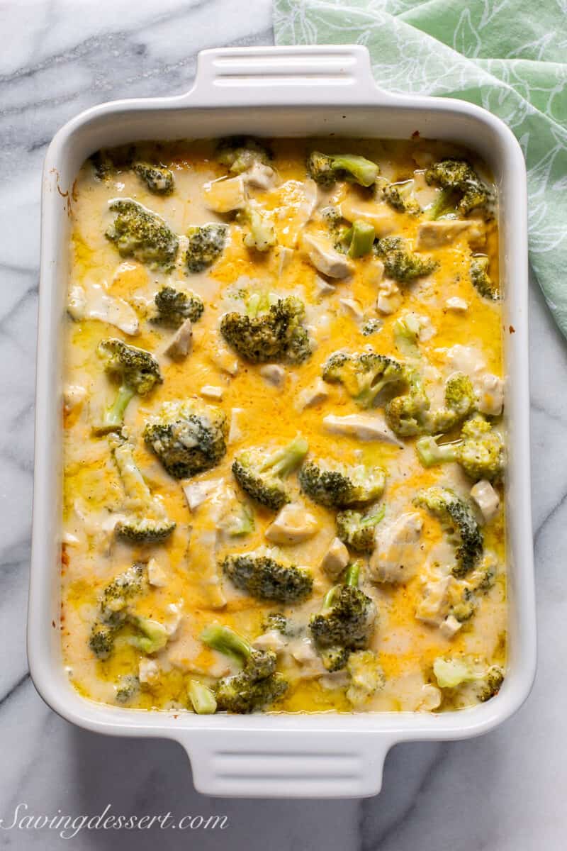 a baked chicken casserole with broccoli and melted cheddar cheese