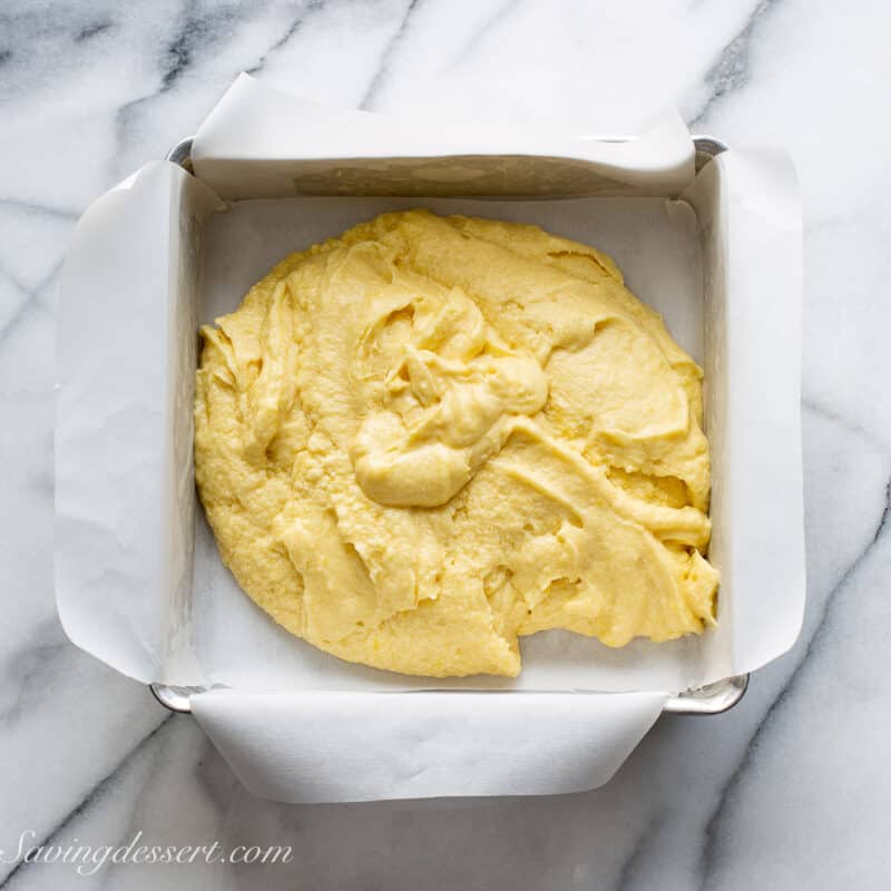 a square baking pan with lemon brownie batter