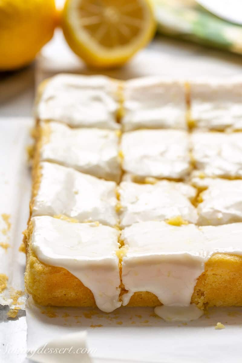 a side view of lemon brownies topped with a lemon icing
