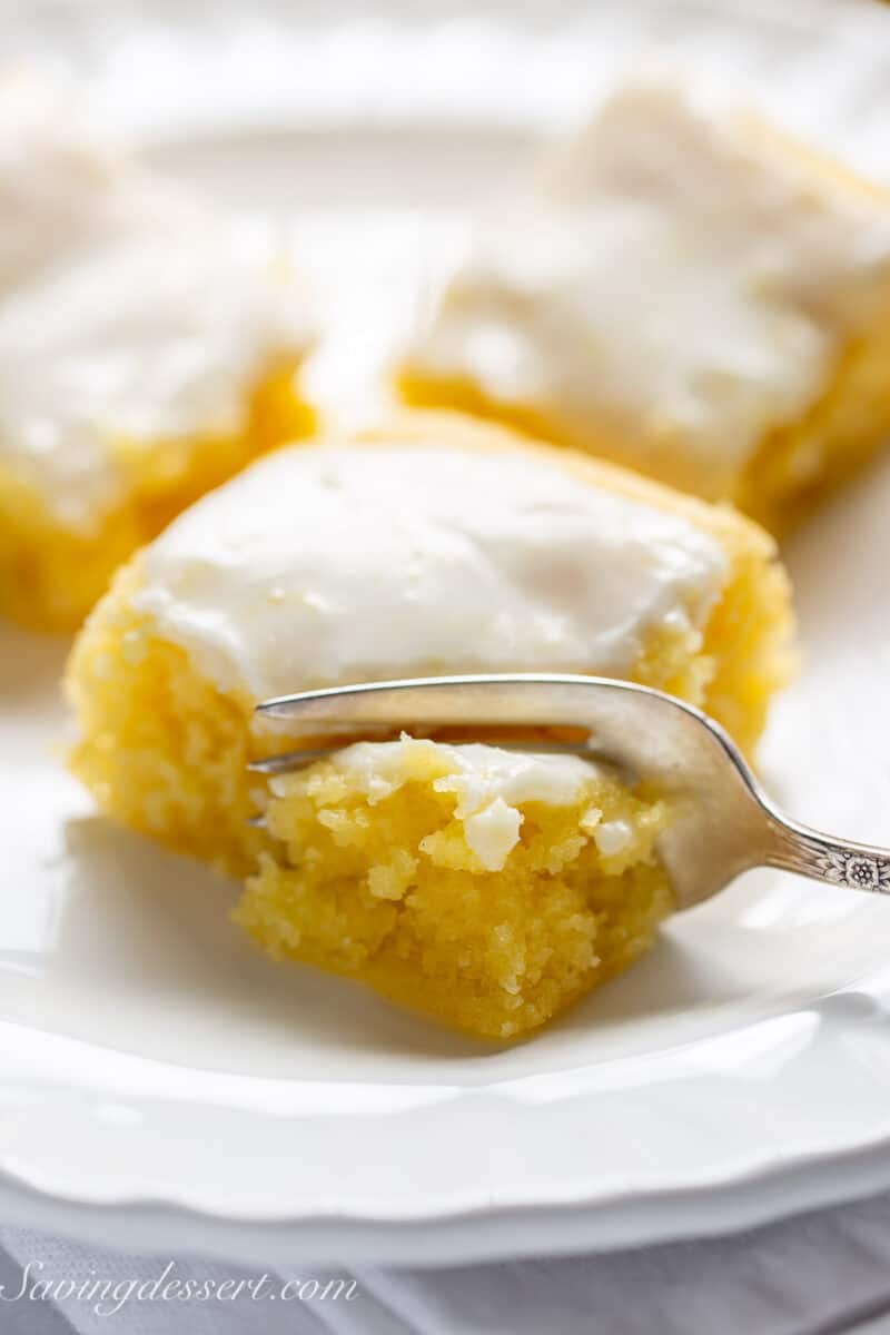 closeup of a lemon brownie being cut with a fork