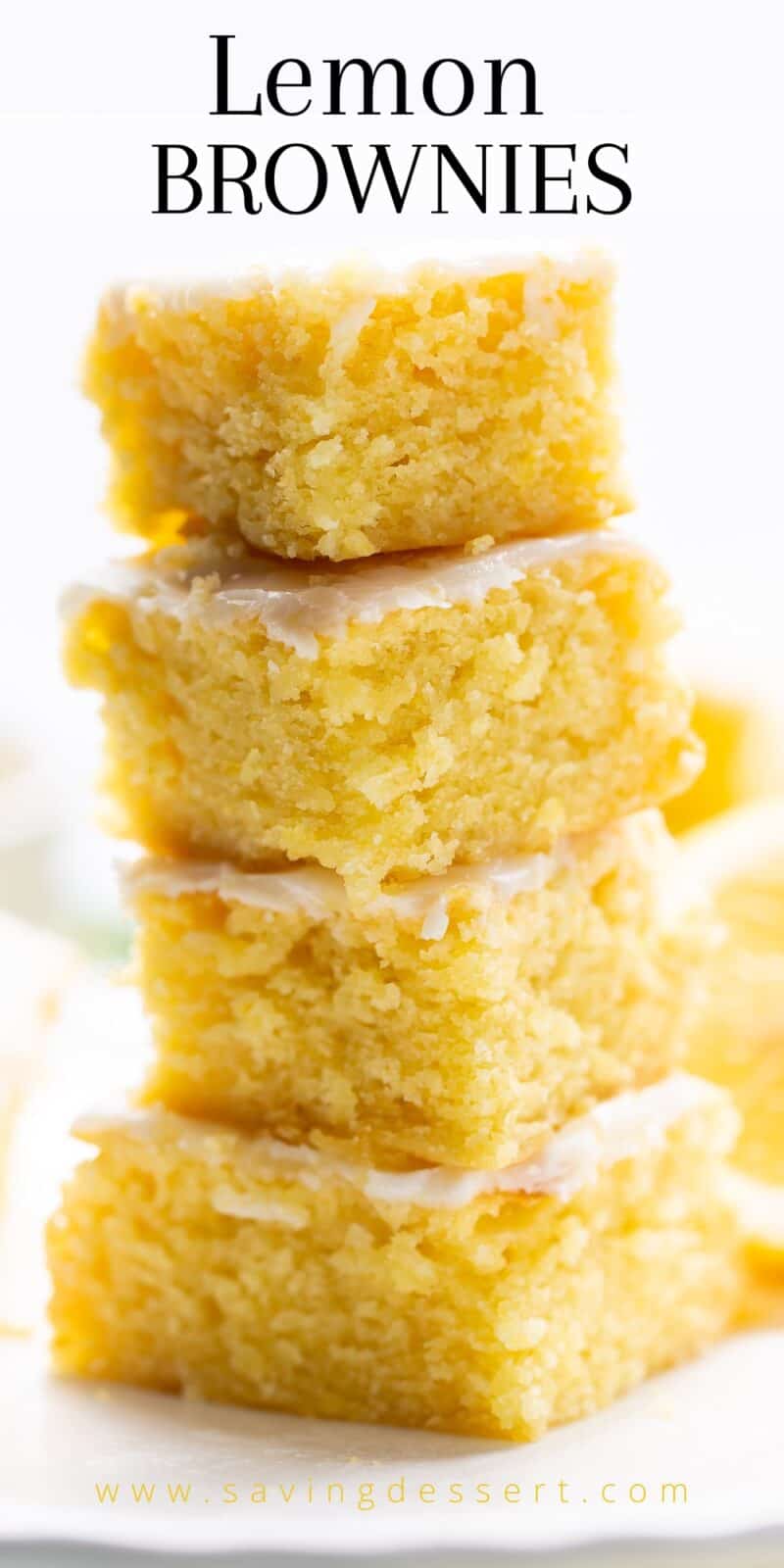 A stack of lemon brownies topped with a lemon icing