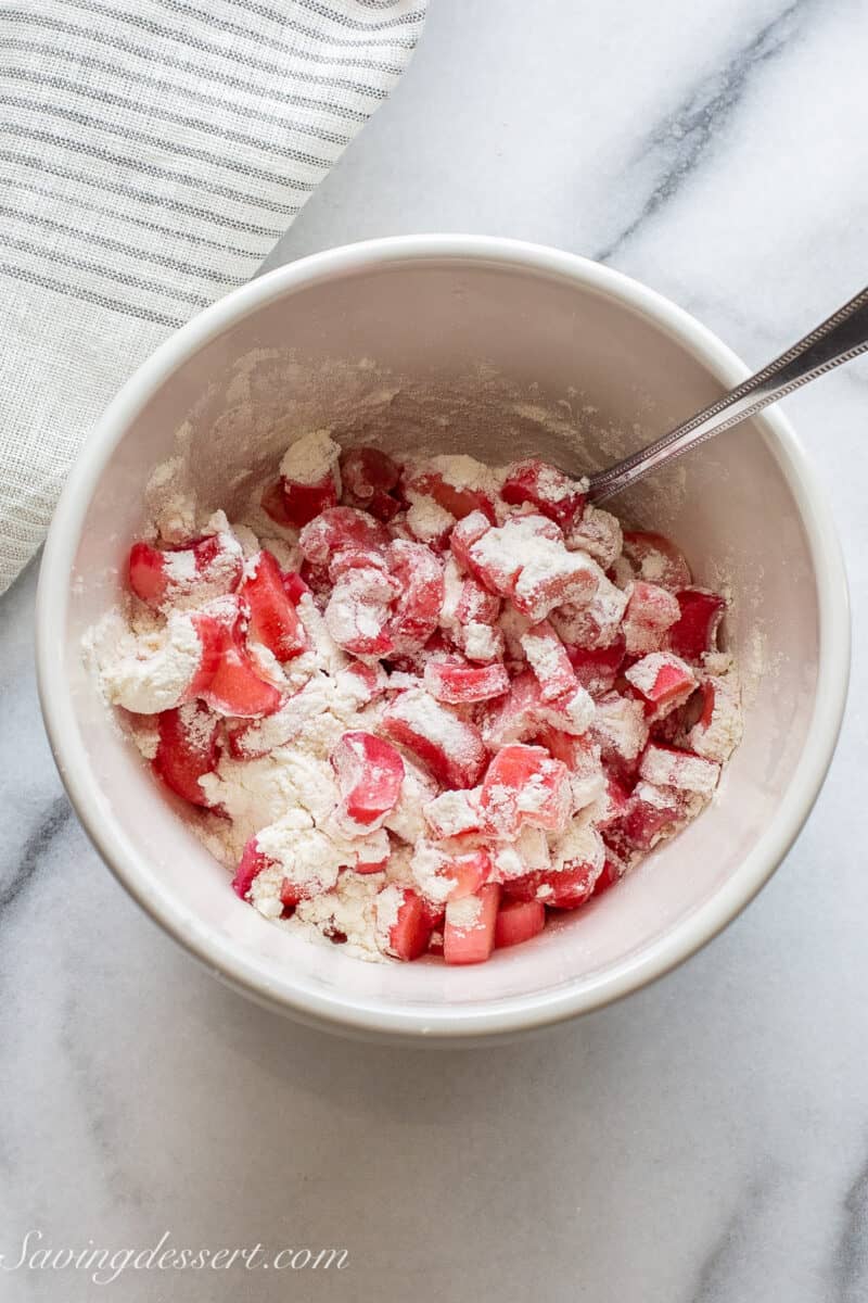 a bowl of sliced rhubarb tossed in flour