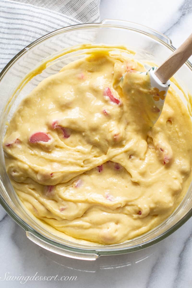 rhubarb cake batter in a bowl with a spatula