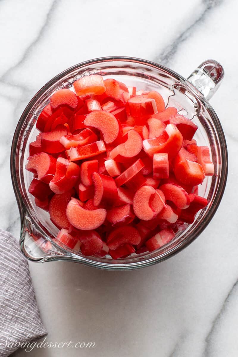 overhead view of a large measuring bowl filled with sliced rhubarb