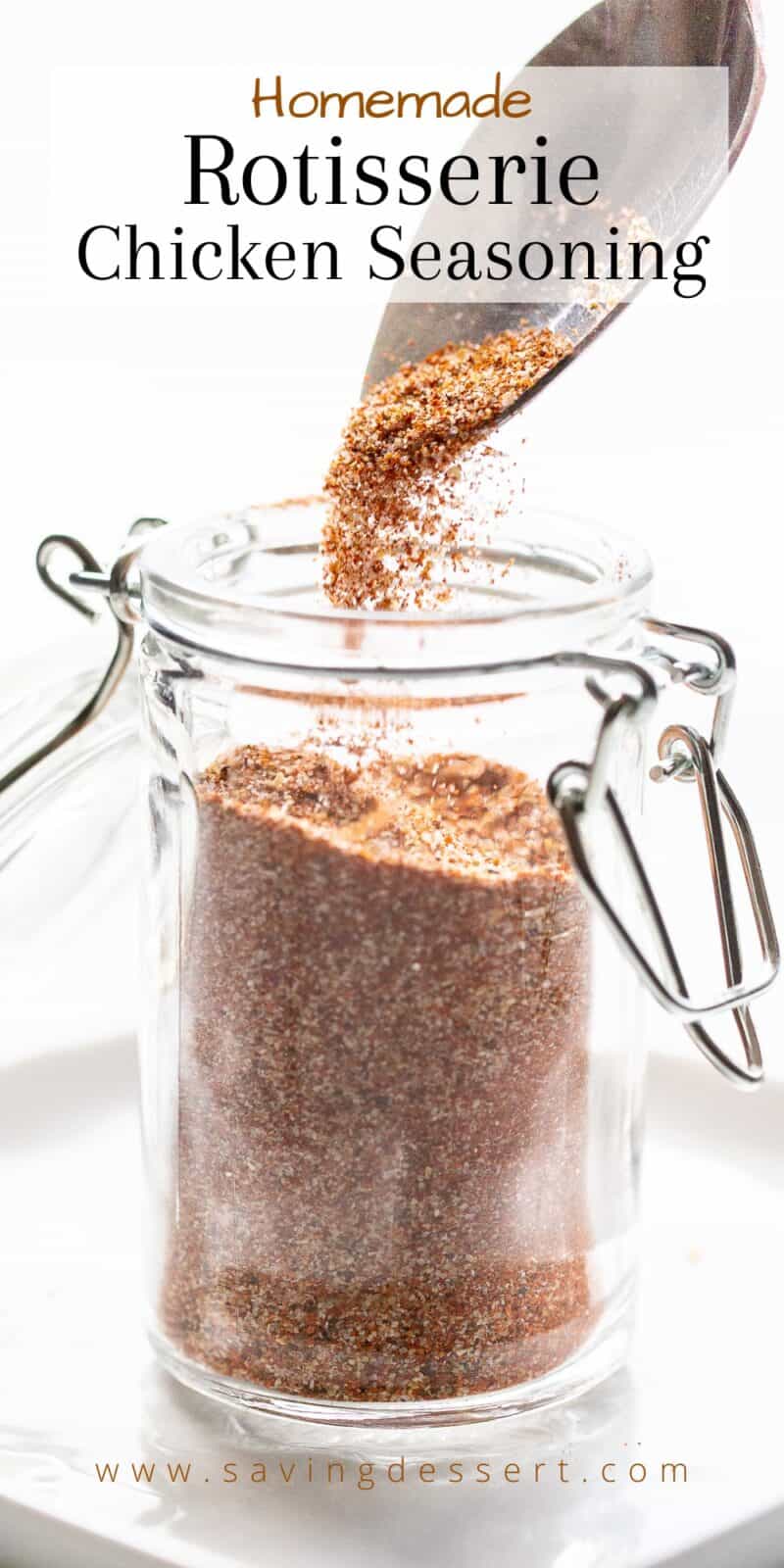 a jar of rotisserie chicken seasoning being poured in with a spoon