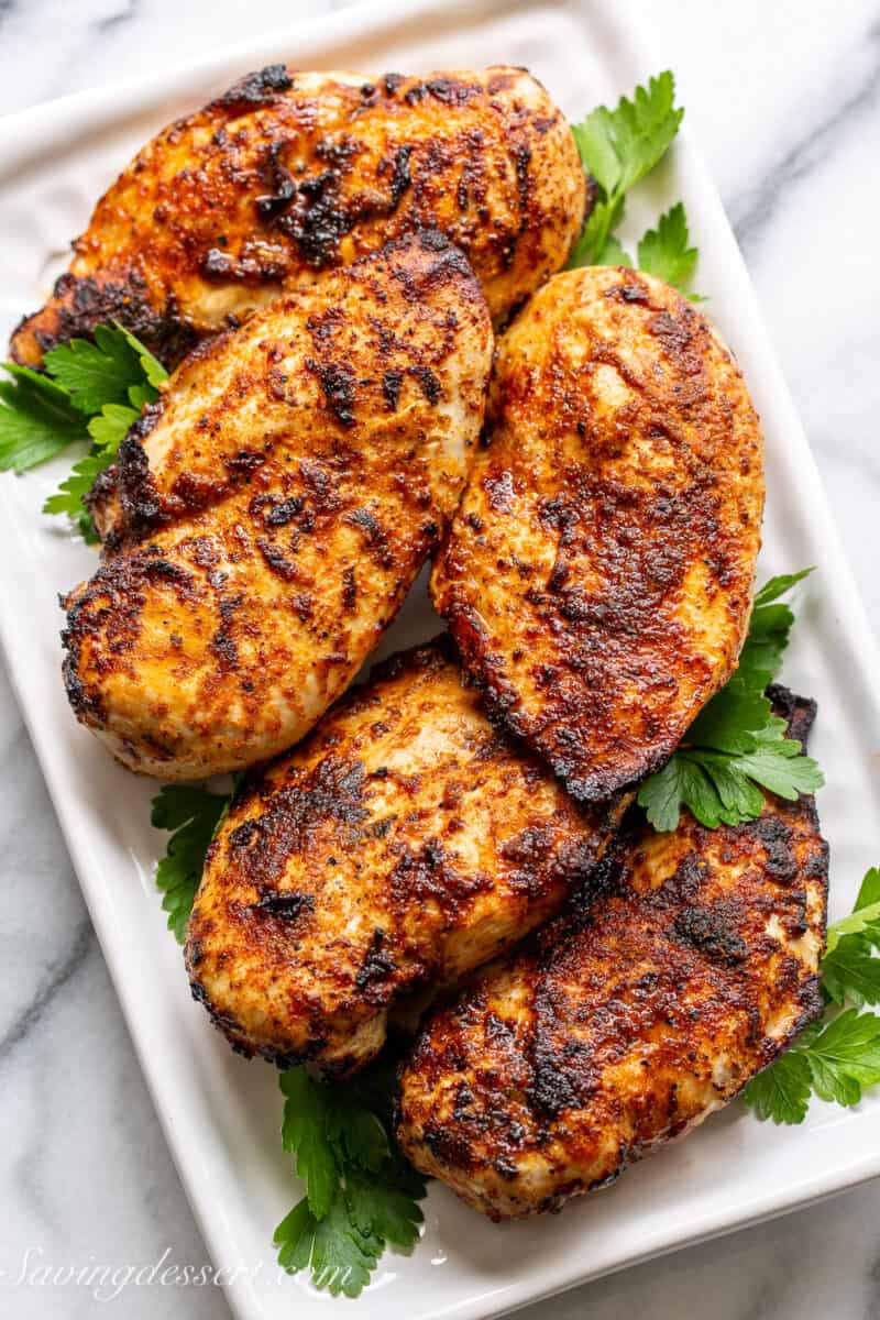 a platter filled with boneless chicken breasts cooked in an air fryer