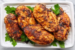 a platter filled with air fryer chicken breasts with rotisserie seasoning