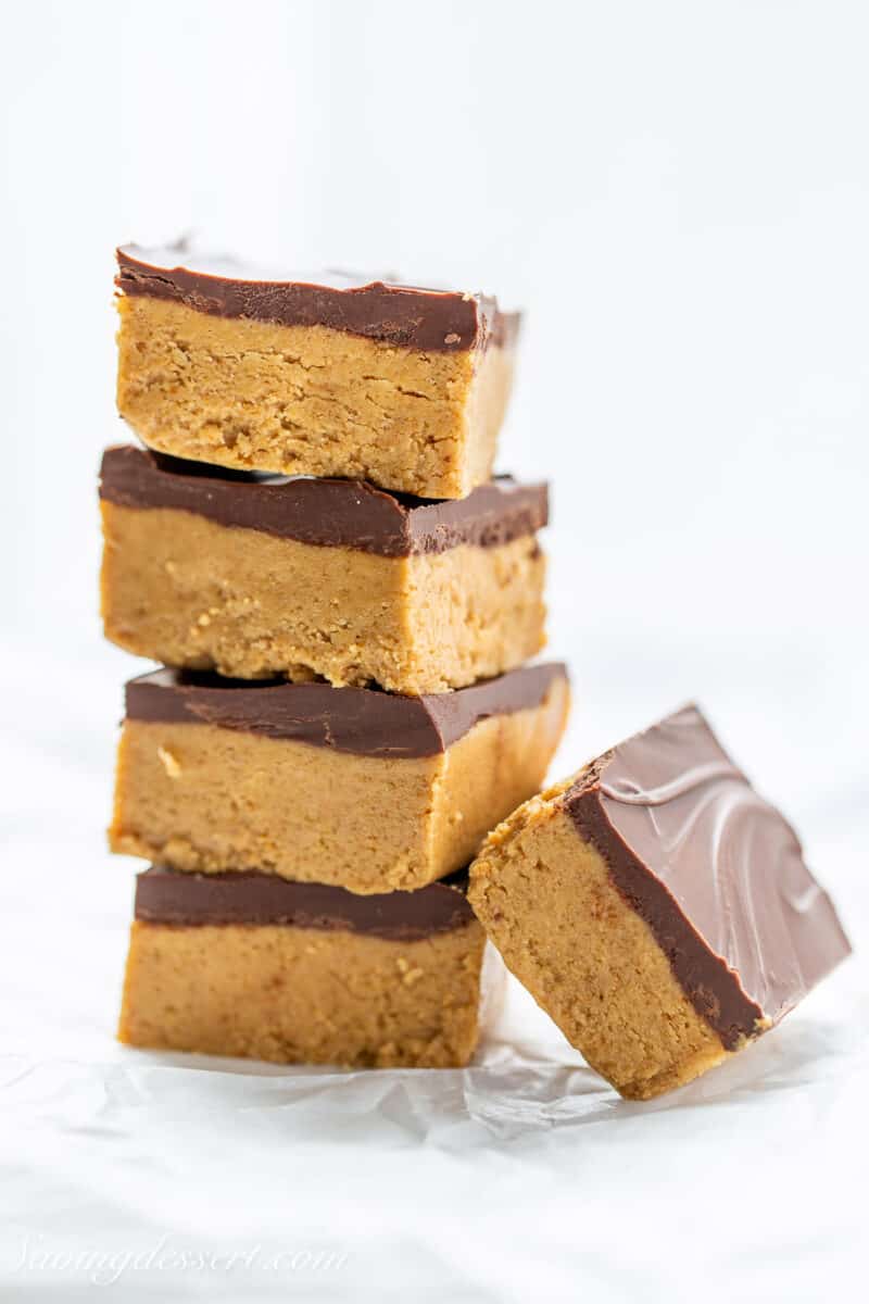 a small stack of peanut butter bars with chocolate on top