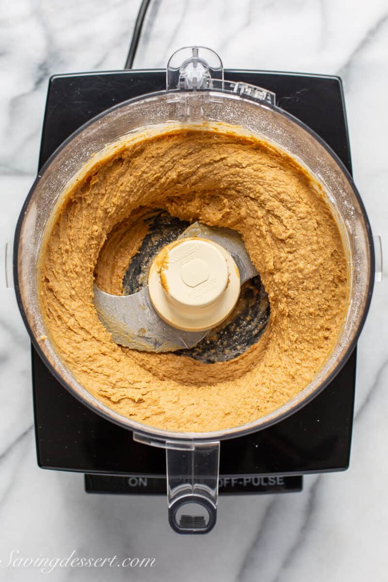 an overhead view of a food processor with a blended peanut butter filling