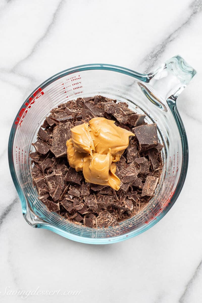 an overhead view of a measuring cup filled with chocolate chips and peanut butter