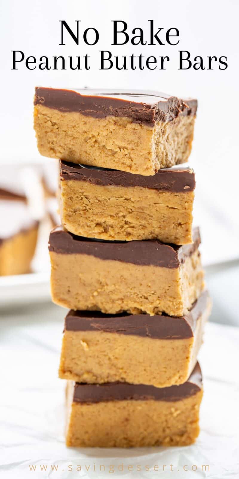 A stack of no bake peanut butter bars topped with chocolate
