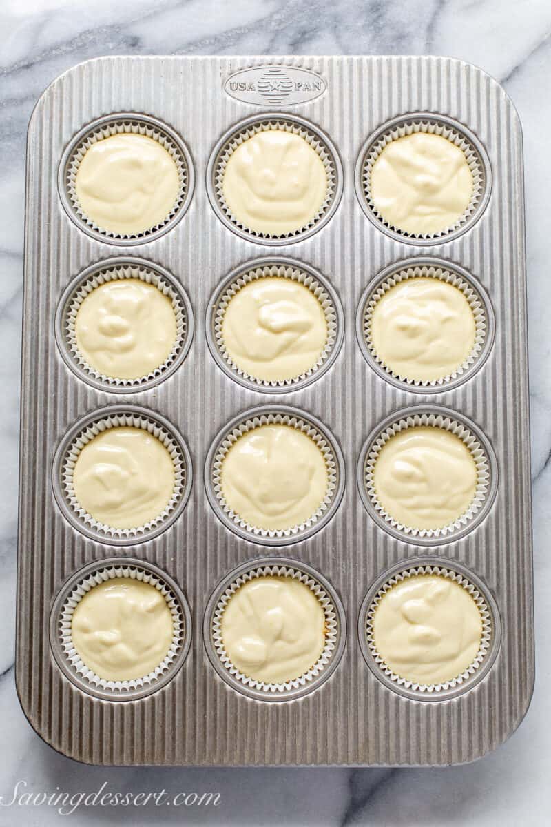 cheesecake batter in a muffin tin