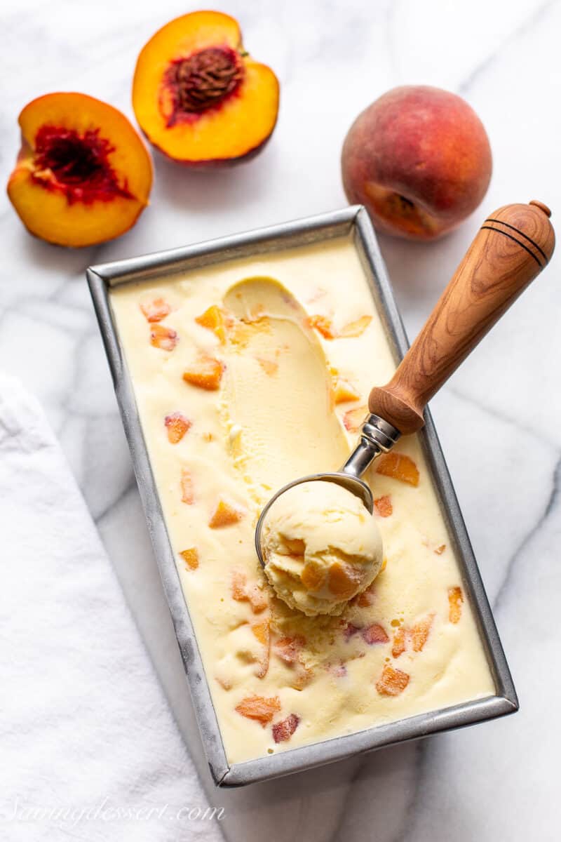 an overhead shot of a loaf pan filled with peach ice cream