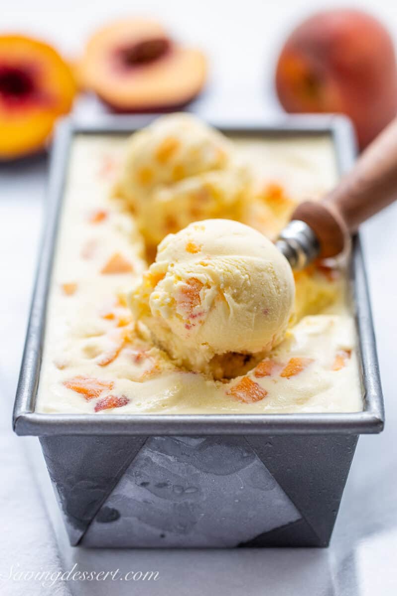 A side view of a pan filled with peach ice cream