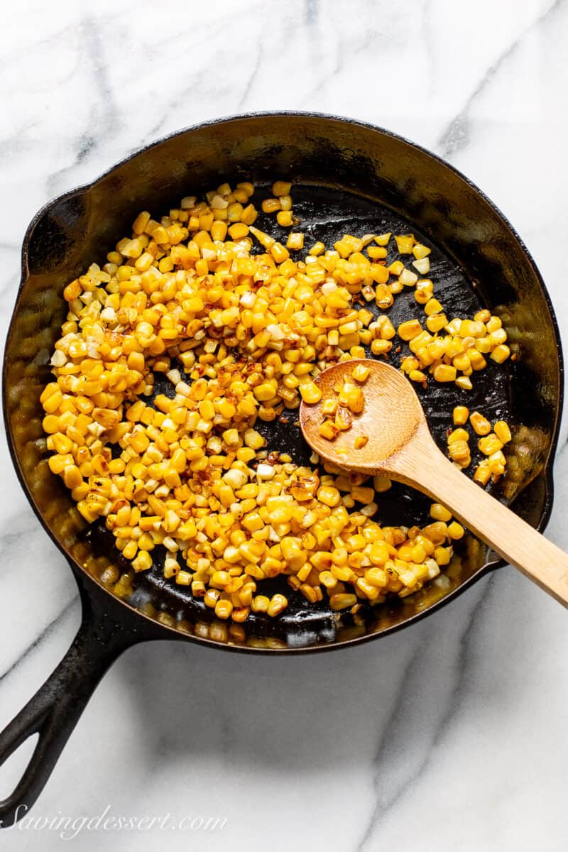 a cast iron skillet filled with corn